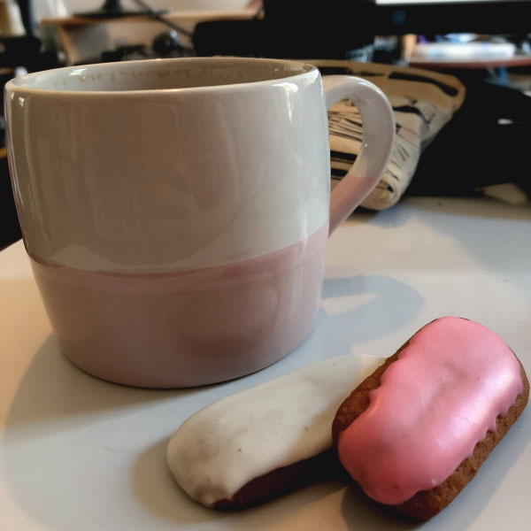 a photo of a cup of coffee and two honey jumble biscuts